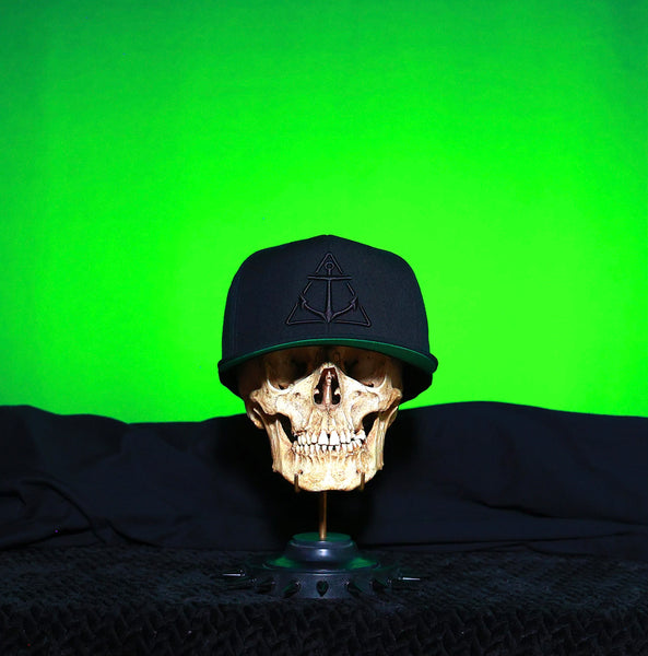 Black on Black logo Flat Bill Hat- Green under cap.